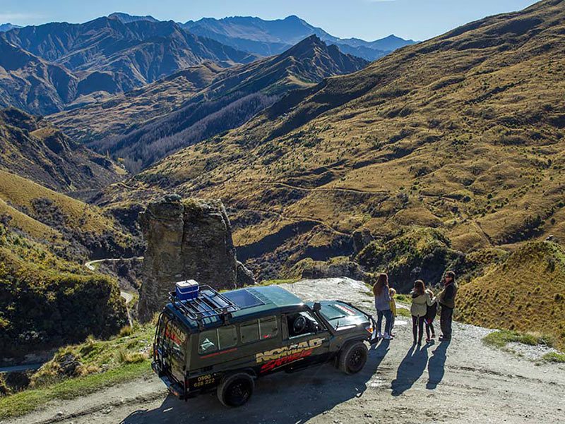 Passagers d'un 4x4 qui admirent la vue de Skippers Canyon à Queenstown en Nouvelle-Zélande