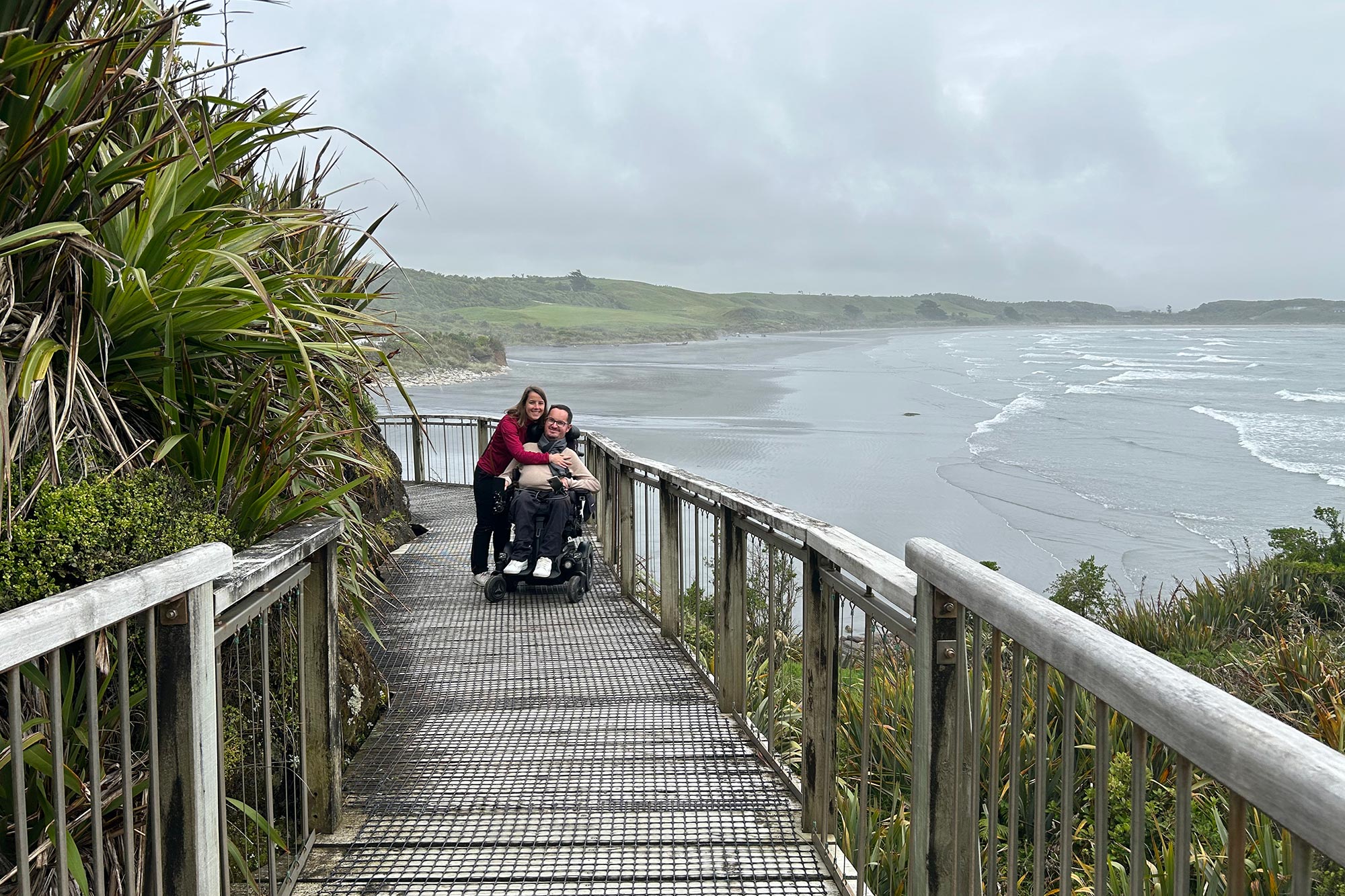 Personne en fauteuil roulant sur un chemin de la West Coast en bord de mer en Nouvelle-Zélande